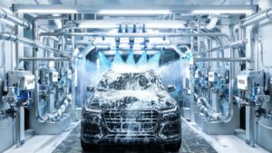 Automated car wash system with chemical dispensing pumps and spray arches applying soap and wax