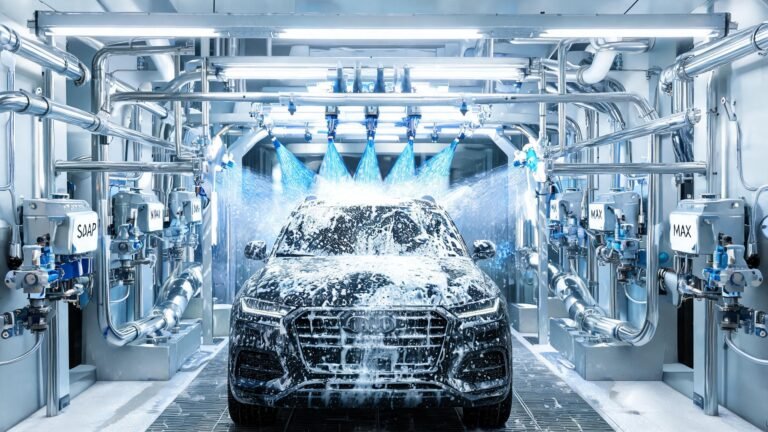 Automated car wash system with chemical dispensing pumps and spray arches applying soap and wax