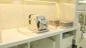 Peristaltic pump delivering chemicals in a semiconductor cleanroom manufacturing environment